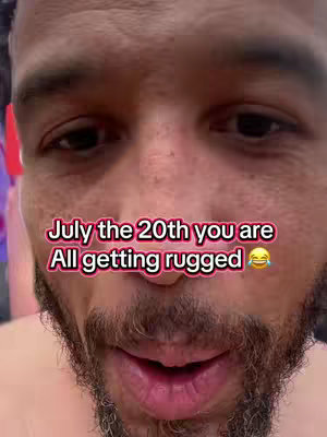 Close-up of a man's face with text overlay. The man is looking directly at the camera with a neutral expression. The text overlay is in a bright pink color. The background is plain, with focus on the man's face.