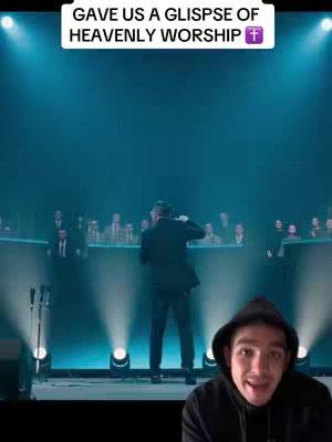 The image captures a live performance with a musician onstage, illuminated by spotlights, and a choir or audience in the background. The image is overlaid with text that emphasizes the worship aspect. The lower right shows a creator's face reacting to the worship.