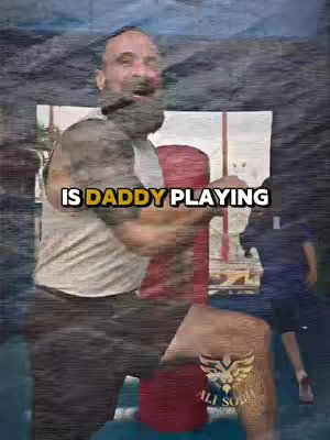 The cover image shows a bearded man with a surprised expression, possibly playing with a child outdoors. Text overlayed on the image reads: "IS DADDY PLAYING". The background appears blurred and shows a hint of an outdoor scene, possibly a park.