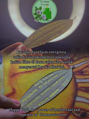 A close-up shot featuring a hand holding a leaf with handwritten text. Behind the leaf, a blurred background with a circular light and other leaves with text are also visible.