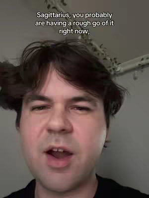 A man with dark hair, wearing a black shirt, speaks directly to the camera. Text overlays the image, describing the viewer's current state.