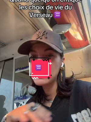 A woman wearing a baseball cap is positioned in front of a window with a blurred background. An overlay includes a red square with an astrological symbol and text.