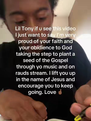 A selfie-style video with a young person in the foreground, slightly out of focus, writing on a piece of paper. The background is blurred, suggesting an indoor setting. Text is overlaid on the image, expressing a message of support and encouragement.