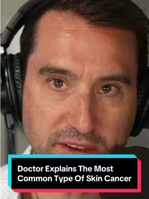 A close-up shot of a man wearing headphones and facing the camera. The image is brightly lit, and the man appears to be speaking. A text overlay at the bottom reads, "Doctor Explains The Most Common Type Of Skin Cancer."