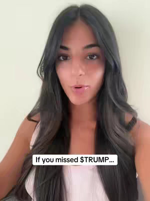 A young woman with long, dark hair is centered in the frame, looking directly at the camera. She is wearing a light pink tank top and her facial expression suggests she is speaking. A white rectangular text overlay at the bottom reads, 'If you missed $TRUMP…'. The background is a plain, light-colored wall.