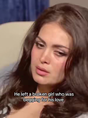 A close-up shot of a woman with long, dark hair and heavy eye makeup. She is looking downwards with a sorrowful expression, with text overlaid in the lower area.