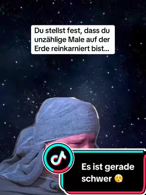 A person with a gray headscarf is looking down, with a TikTok logo in the front. Overlay text in a bubble states, 'Du stellst fest, dass du unzählige Male auf der Erde reinkarniert bist...'. Additional text in a black and red banner says, 'Es ist gerade schwer' with a crying-face emoji. A starry background fills the space.