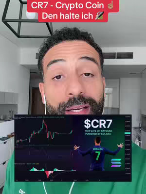 A man with a beard holds up a screen showing a cryptocurrency graph. Text overlays the screen, and in the background are kitchen cabinets. The man is wearing earpods.