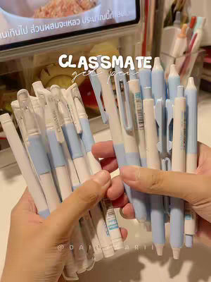 A person's hands are holding a large collection of pens organized together. The pens are primarily white and light blue. In the background, there is more stationery arranged. The hook text is in a white box.