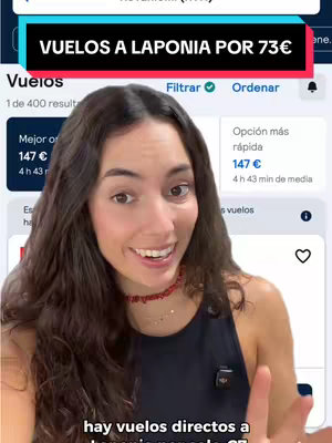 The image shows a young woman smiling and pointing upwards, holding her phone to the side, with text overlaid on a black and teal banner at the top that reads "VUELOS A LAPONIA POR 73€". Behind the woman are blurred interface elements that appear to be a flight booking website, with icons and various data presented. The woman has dark brown hair, and wears a red beaded necklace, a black top and she is in a well-lit indoor setting.