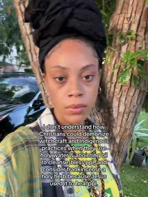 A woman with a head wrap stands in front of a tree, looking directly at the camera. Text is overlaid on the image.
