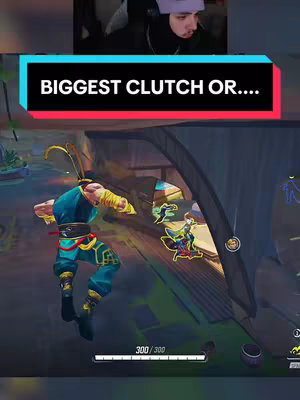 The cover image is a screenshot from a video game, likely a shooter or action game, with the creator's face in a small inset at the top. A large text banner reads "BIGGEST CLUTCH OR...." The game scene shows a character in blue and yellow, mid-air, seemingly attacking or moving towards other characters. The overall color scheme is bright with blues, yellows, and greens.