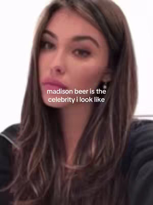 A selfie-style shot features a young woman with long, wavy brown hair. She has pink lipstick. Text overlayed on the image states "madison beer is the celebrity i look like."