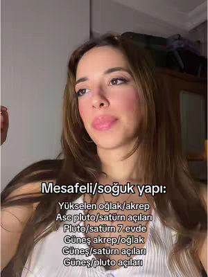 A woman with long brown hair, wearing a white top, looks slightly upward, with text overlaid at the bottom of the frame.
