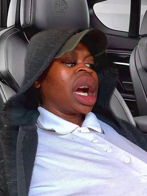The cover image depicts a person, likely a woman, in the driver's seat of car, face making an exaggerated expression with the mouth open as if they were shouting. She is wearing a cap, a hoodie and a white top with the car's interior subtly visible in the background.
