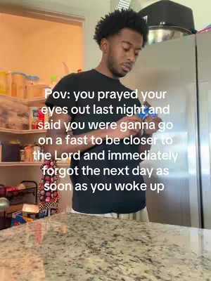 A young Black man stands in a kitchen, wearing a black t-shirt and looking down. Text overlayed on the image reads a humorous anecdote about forgetting a fast after praying.
