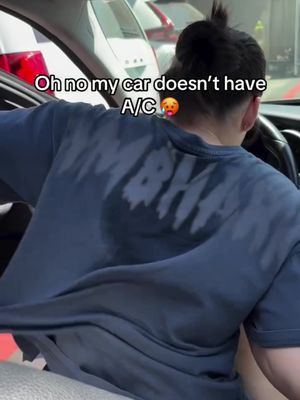 A person in a blue shirt, drenched in sweat on the back, is sitting in a car. The person has short hair and a shirt with a partially visible logo. The hook text is overlaid on the image.