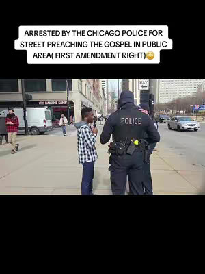 A man is being confronted by police officers on a city street. Text overlayed on the top indicates that the man was arrested for street preaching. The scene is set outdoors with buildings and parked vehicles in the background.