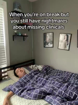 A person lying in bed covered by a patterned blanket is the central focus. The room has a grey wall, a window with blinds, and black framed photos. Text overlays the top of the image.
