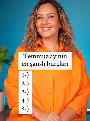 The cover image is a medium shot featuring a woman with wavy, light brown hair. She's wearing an orange button-down shirt and smiling widely at the camera. Behind her is a bright blue background. In the foreground, a white rectangular box overlay contains the title text "Temmuz ayının en şanslı burçları" and a numbered list from 1 to 5.