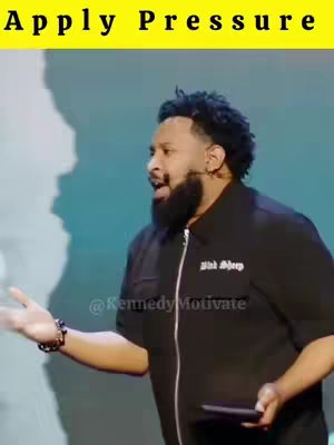The image features a man with a dark beard speaking passionately, captured from the chest up and angled slightly to the side. The background is a blurred, light teal. Text at the top reads Apply Pressure in yellow. The man is wearing a black shirt