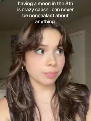 A young woman with long, wavy brown hair and a neutral expression is looking slightly to her right. Text overlays the image, stating that having a moon in the 8th house is crazy because she can never be nonchalant about anything.