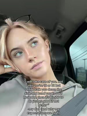 A young woman with blonde hair and glasses perched on her head is looking up thoughtfully. Text overlay in the bottom half quotes a father's advice about marriage, against a soft-focus background within what appears to be a car.