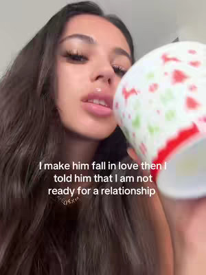 A woman is holding a patterned mug near her face, with the bottom of the mug in focus. The image is from her chest upward. Text is overlaid toward the bottom of the image.