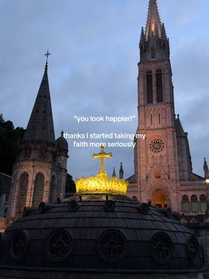 A nighttime image showing a church with two tall spires, one to the left and a larger one to the right. Between them is a dome-shaped structure with a golden cross on top. The sky is a dusky blue, and text overlays are visible on the image.