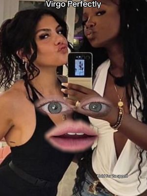 A selfie-style photo featuring two women posing with a playful filter applied. The filter creates a cartoonish face with large, stylized eyes and a wide mouth superimposed over their faces. The background is blurred, and the women are dressed in stylish attire, enhancing the selfie aesthetic.