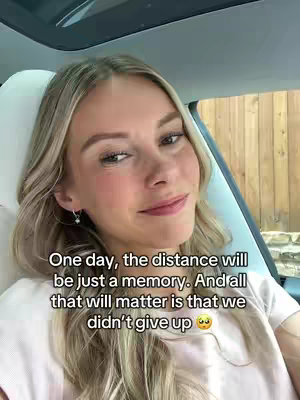 A woman with long, blonde hair is seen from the chest up, sitting in a car. She's looking at the camera and has a soft smile. Text is overlaid on the image with an emotional message.