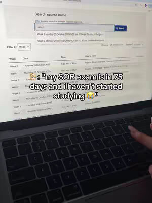 A laptop screen is the primary focus, displaying search results for a course. The screen is slightly angled, with the keyboard visible at the bottom. A hand is seen hovering over the keyboard, suggesting active interaction. The background is a light color, likely a desk, with details of the website on the screen.