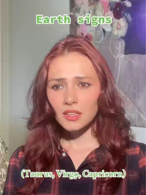 A woman with auburn hair looks towards the camera with a slightly concerned expression. Green text at the top reads \"Earth signs\". There is a floral painting visible in the background, and text at the bottom reads \"(Taurus, Virgo, Capricorn)\"