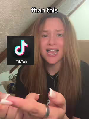 A young woman with long blonde hair is centered in the frame, making a distressed facial expression with her mouth open as though in shock or surprise. A TikTok logo is positioned to her left. The background is a neutral tone.