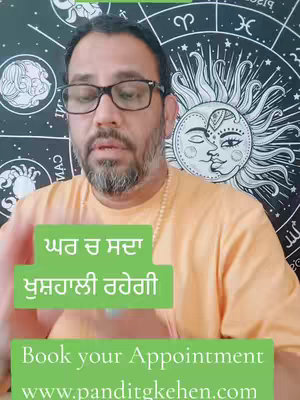 A man in glasses and an orange top is centered in the shot, with astrological symbols in the background. Green boxes with white text overlay the image, one in a light green. The text reads, 'Book your Appointment www.panditgkehen.com.'