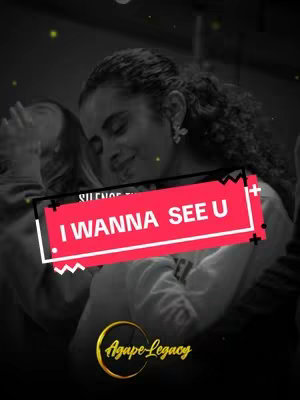 The image is a grayscale photo featuring two individuals embracing. A text overlay reading "I Wanna See U" is prominently displayed on a red rectangle, with a white zigzag design underneath. The Agap-Legacy logo, a golden circular emblem, is placed near the bottom.