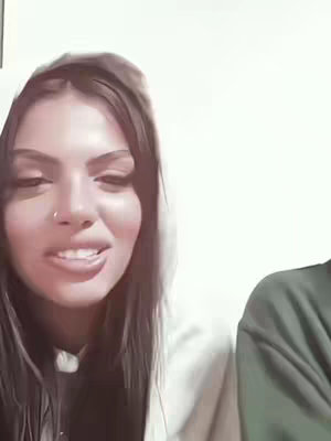 The cover image presents a close-up of a young woman's face, positioned slightly off-center to the left. She is wearing a white hooded sweatshirt, the soft fabric visible around her face and on her shoulders. Her dark hair frames her face. She has a nose ring, and appears to be in the middle to a conversation.