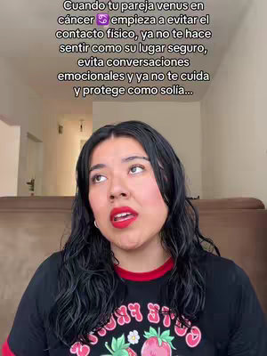 A woman with long dark hair and red lipstick is looking upwards and to the left. Above her, text overlays the image. The background appears out of focus, possibly a living room with a couch visible.