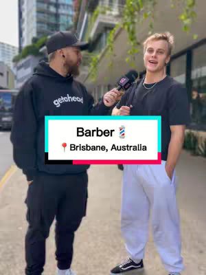 Two men stand outside, one holding a microphone, with a graphic overlay indicating the video's subject about Barber salaries in Brisbane, Australia. The background includes a building facade and plants.