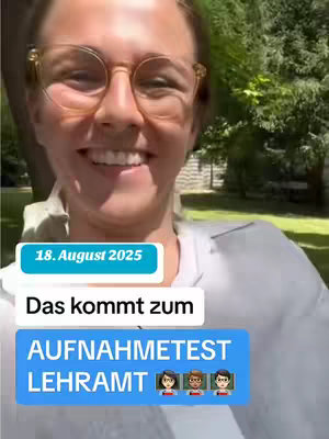 A woman with blonde hair and glasses smiles broadly while standing outside. Text bubbles are overlaid, including the date "18. August 2025" in a light teal box, followed by text in a white box stating "Das kommt zum" above a blue box containing the text "AUFNAHMETEST LEHRAMT" along with three emoji figures. The background shows out-of-focus greenery.