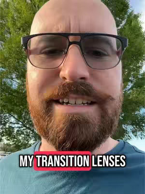 A close-up shot of a bald man wearing glasses with transition lenses, with the text "MY TRANSITION LENSES" overlaid on the image.