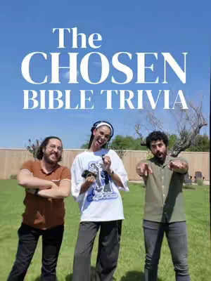 The cover image shows three people standing in a backyard setting, against a backdrop of a bright blue sky. Above them, the text "The CHOSEN BIBLE TRIVIA" is prominently displayed in a casual, rounded sans-serif font. From left to right, there is a man with a beard, wearing an orange shirt and jeans, smiling with his arms crossed. In the middle is a woman with her hands held near her face, wearing a white t-shirt, dark pants, and a headwrap; she is smiling widely. The person on the right, also wearing a t-shirt and jeans, has a beard and is pointing towards the camera; all three people appear outdoors on a sunny day