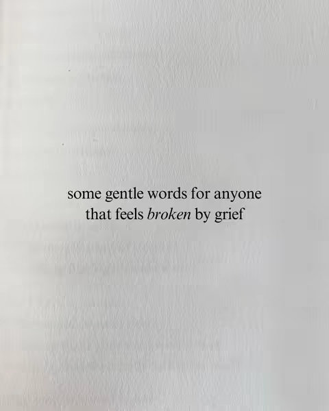 The image features a page from a book, with text centered on a white background. The text reads, 'some gentle words for anyone that feels broken by grief', using a simple, readable font. The page appears lightly textured with subtle gray tones, suggesting the physical presence of the book.