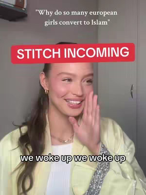 A woman with long dark hair, wearing a yellow-beige jacket, smiles in a selfie-style shot. A red bar, labeled "STITCH INCOMING" floats above the woman's head. The background is a light grey wall. At the bottom of the frame, text reads "we woke up we woke up".