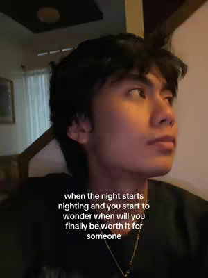A young man with dark hair gazes off-camera, appearing thoughtful. He's lit by soft indoor lighting. Text is overlaid on the image.
