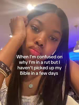 A close-up selfie shows a young woman looking down and slightly to the left, with a contemplative expression. She has dark hair and is wearing a white top. Text overlaid on the image reads, \"When I'm confused on why I'm in a rut but I haven't picked up my Bible in a few days.\"