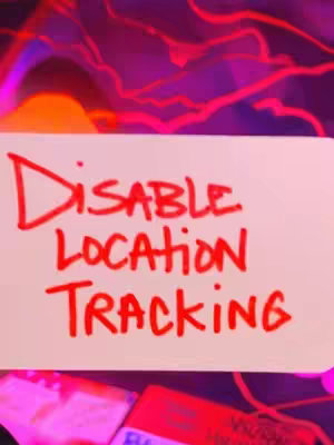 A smartphone screen is partially visible with the words 'Disable Location Tracking' on a white sticky note. the background has a blurred, vibrant, psychedelic abstract design, featuring shades of purple, red, and orange. The overall composition suggests a tech or security-related theme.