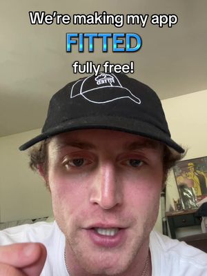 A selfie-style video cover featuring a Caucasian man wearing a black cap with a logo, in front of a background. Overlaid text announces the app 'FITTED' is going 'fully free'.