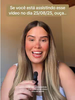 A selfie-style video cover featuring a woman with long blonde hair, wearing a white top, and holding a small microphone. She is smiling with a warm, inviting expression, and the background suggests an indoor setting with a wooden ceiling. Text overlaid on the image announces that the video is about predictions for a specific future date.