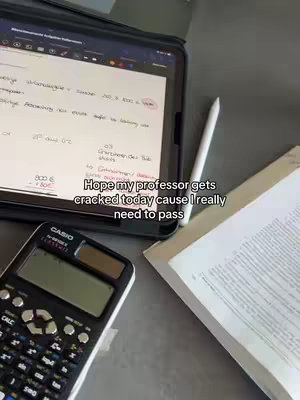 The cover image features a top-down view of a desk or table. On the left, there's a black calculator. In the center, a tablet with handwritten notes. A white stylus lays adjacent to the tablet. To the right, there's an open book with printed text. The text overlay reads: "Hope my professor gets cracked today cause I really need to pass".
